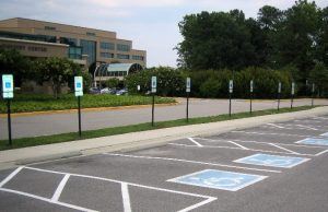 ADA compliance: marked handicap parking spots near a building.