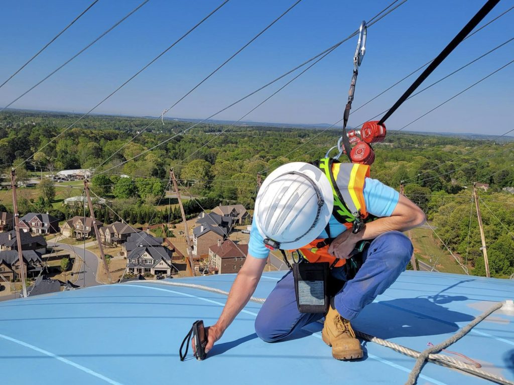 Technician in fall protection on water tower