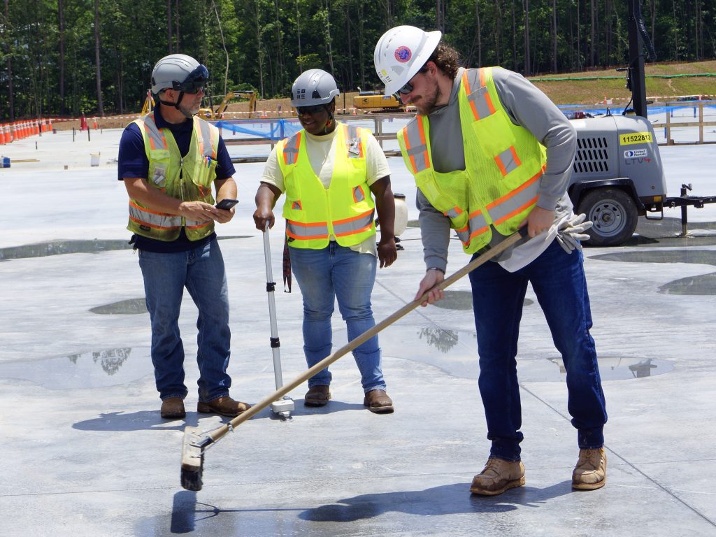 Technicians in PPE on fresh concrete pour